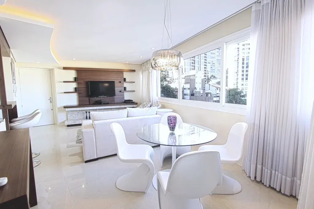 A living room with floor to ceiling glass and a view of the river
