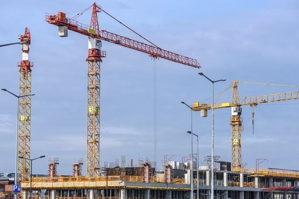 Tower cranes beside a building under construction
